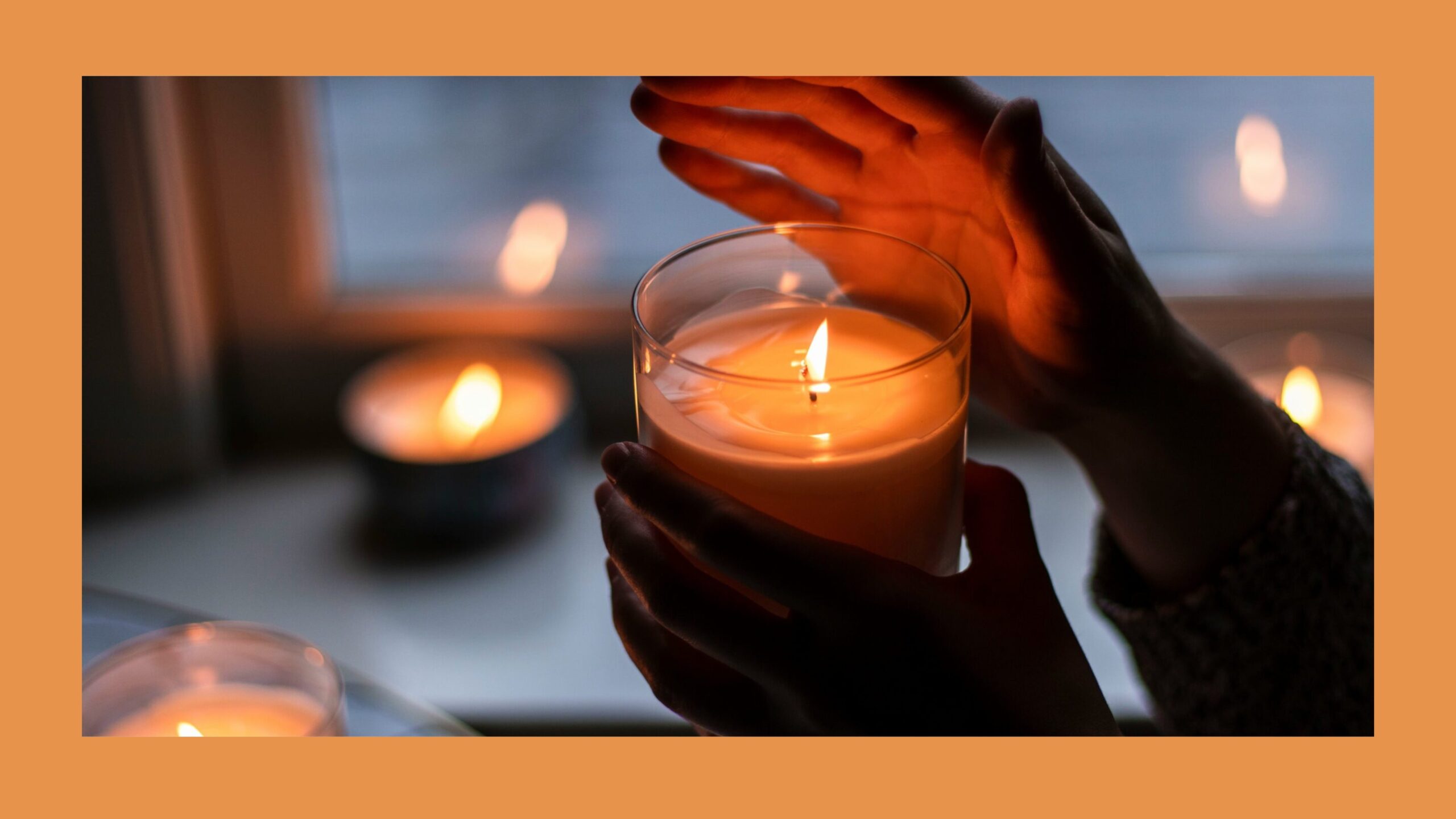 A hand holding a burning candle.
