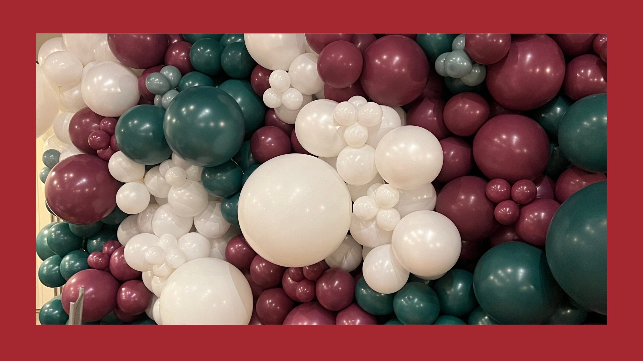 A red, green, and white balloon wall.