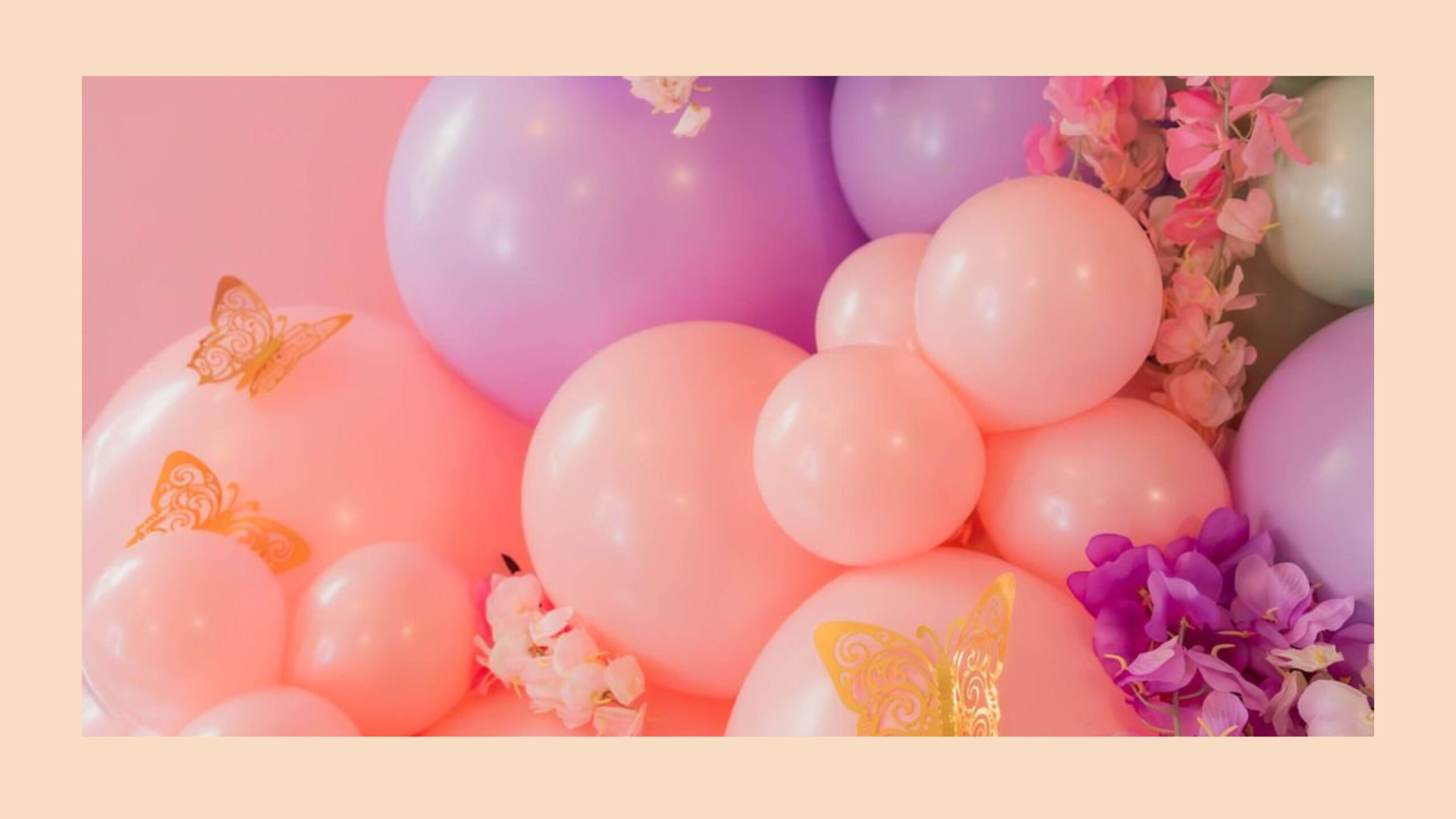 A close up photo of pink and purple balloons.