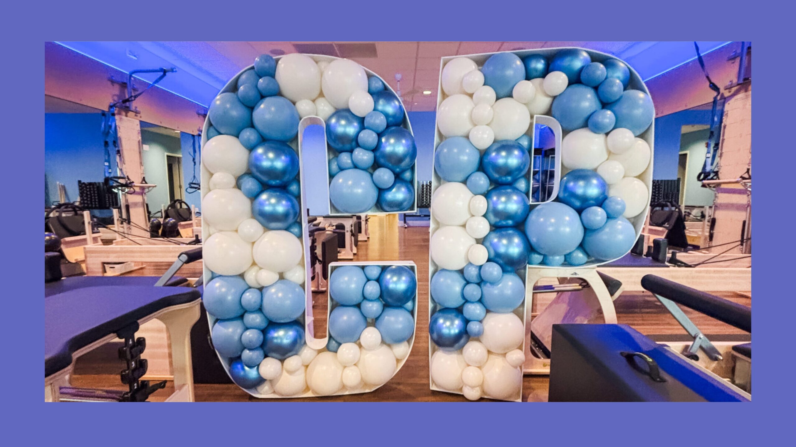 Balloon mosaics in the shape of a C and a P filled with blue and cream balloons.