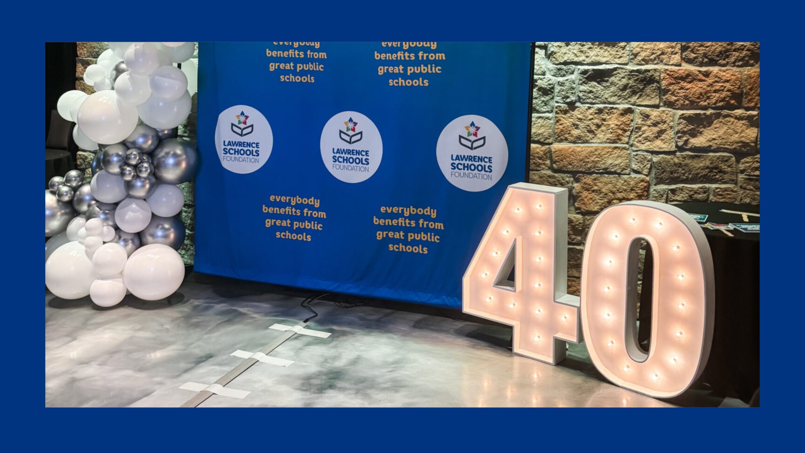 A 4 and a 0 illuminated marquees sit in front of a blue backdrop.