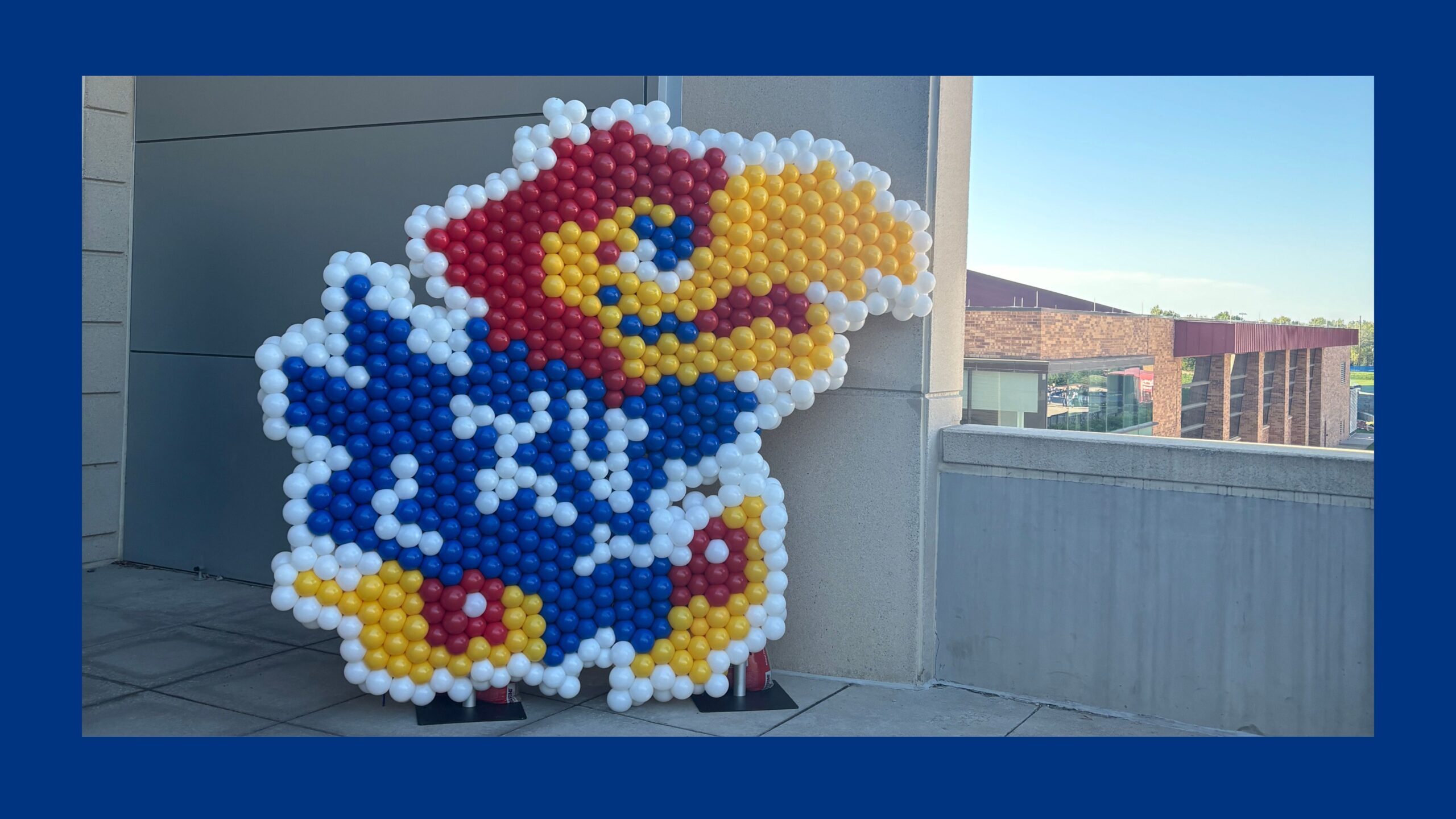 A large Jayhawk mascot made of balloons.